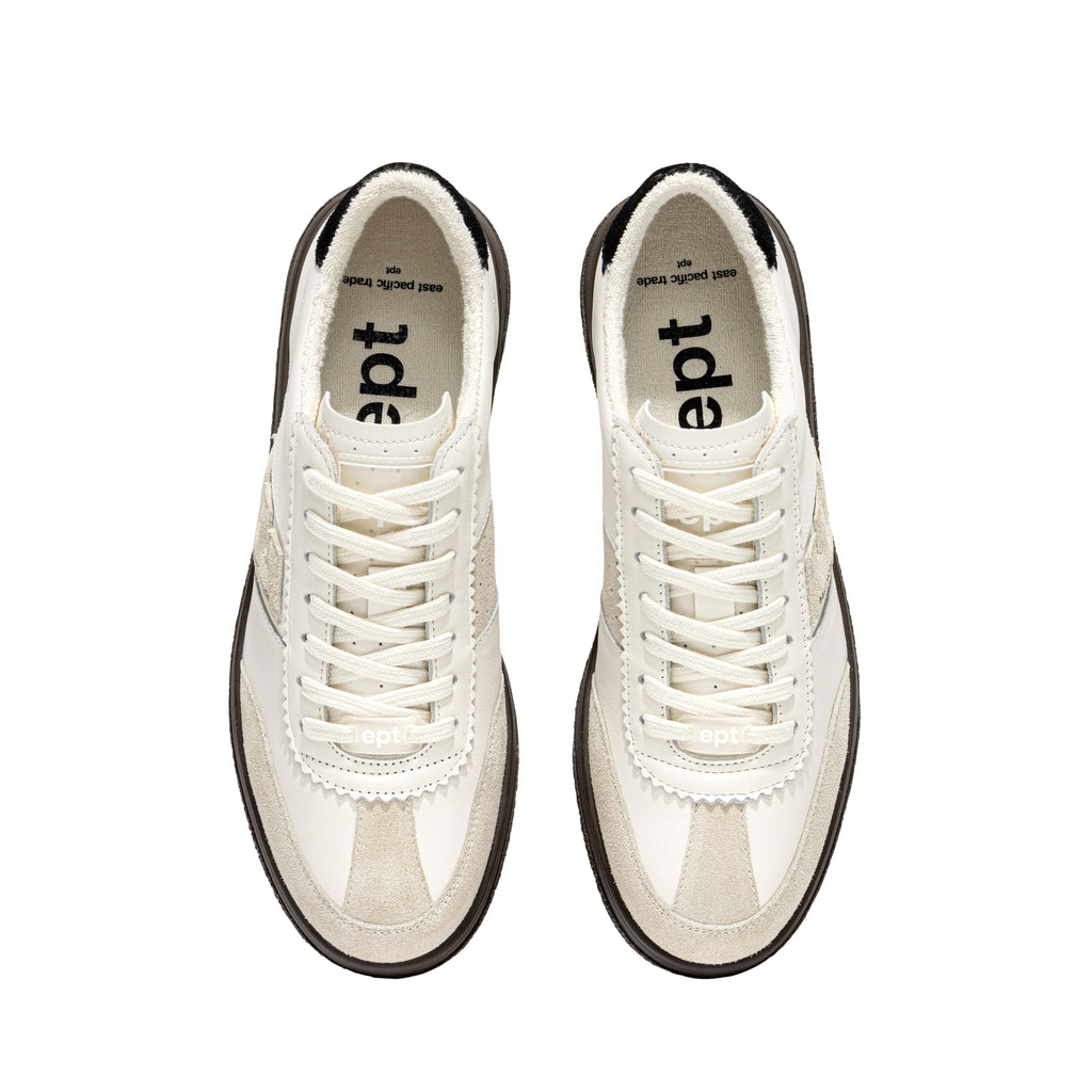 Close-up of leather and suede texture in off white, grey, and black